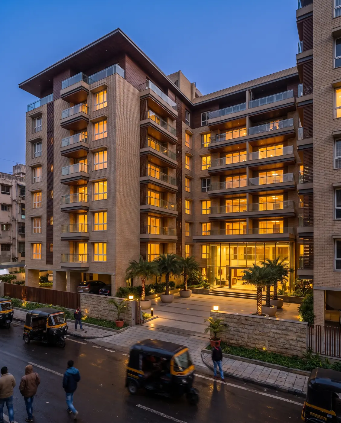Modern residential building lit up at blue hour
